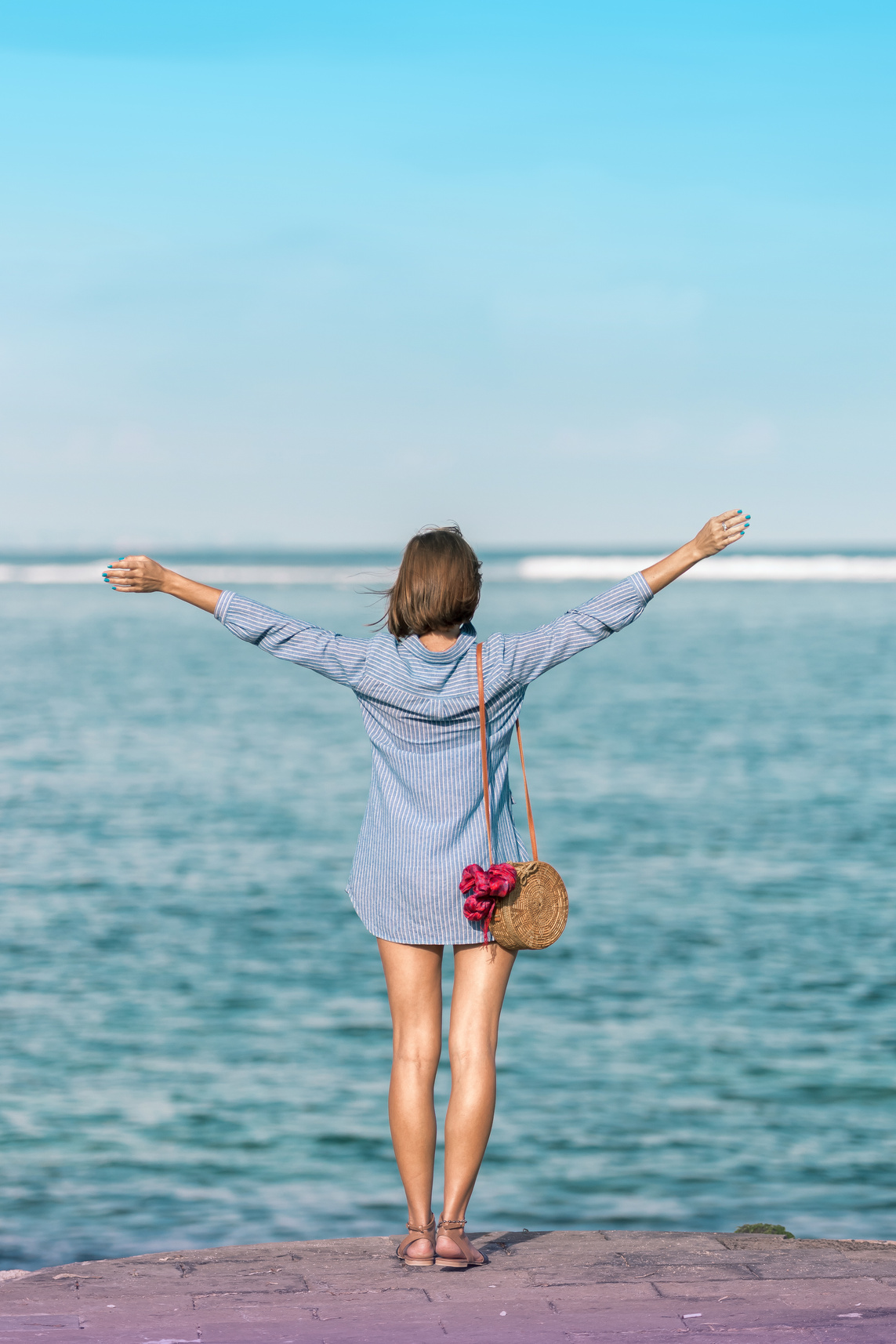 Woman In Blue Dress Shirt Standing Near Body Of Water